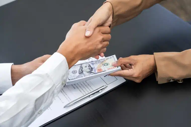people shaking hands exchanging money PPP Loan Forgiveness FAQs: Answers to your Burning Questions
