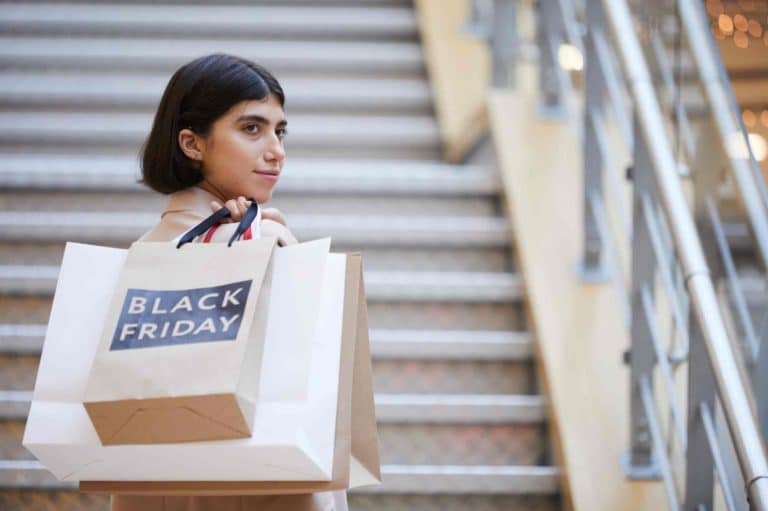 woman holding bag written black friday Perks at Work Best of Black Friday