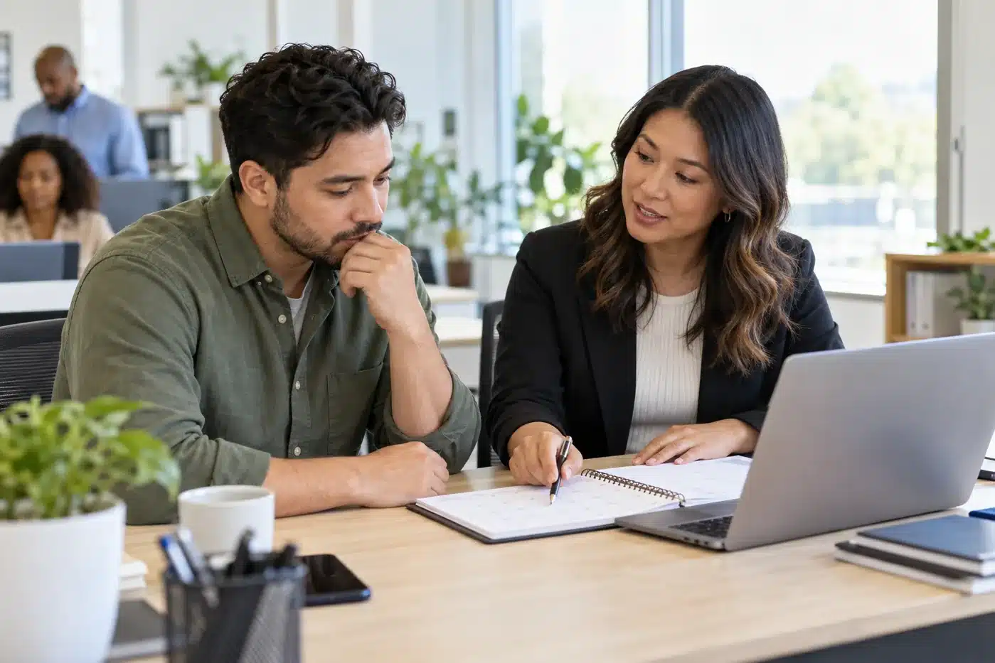 What Happens If I Miss Open Enrollment at Work? Employee discussing missed open enrollment with an HR colleague